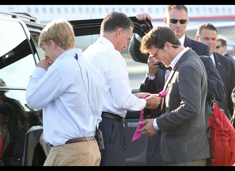 US Republican presidential candidate Mitt Romney hands trip director Charlie Pearce a tie on the tarmac of Love Field airport in Dallas, Texas on September 19, 2012.   AFP PHOTO/Nicholas KAMM        (Photo credit should read NICHOLAS KAMM/AFP/GettyImages)
