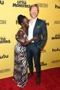 Costars Lupita Nyong’o and Alexander England crack each other up at the New York premiere of their film <em>Little Monsters</em> on Tuesday.