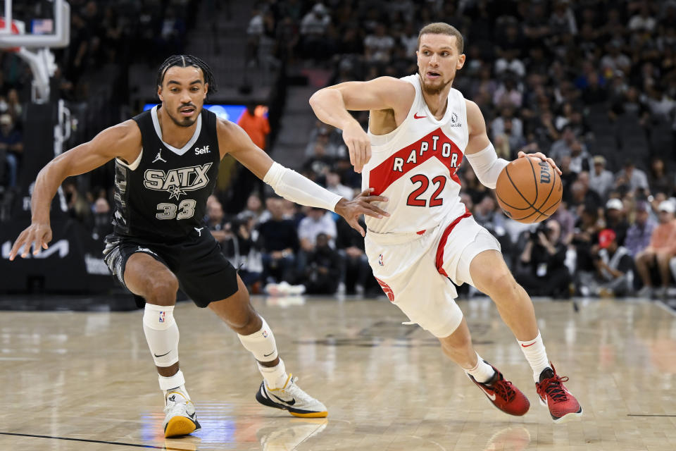 Toronto Raptors' Malachi Flynn (22) drives against San Antonio Spurs' Tre Jones (33) during the first half of an NBA basketball game, Sunday, Nov. 5, 2023, in San Antonio. (AP Photo/Darren Abate)