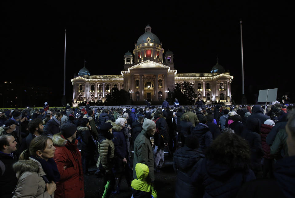 People march during a protest in front of the Serbian Parliament building in Belgrade, Serbia, Saturday, Dec. 8, 2018. Thousands of people are marching in Serbia against the hardline rule of President Aleksandar Vucic and his government. (AP Photo/Darko Vojinovic)