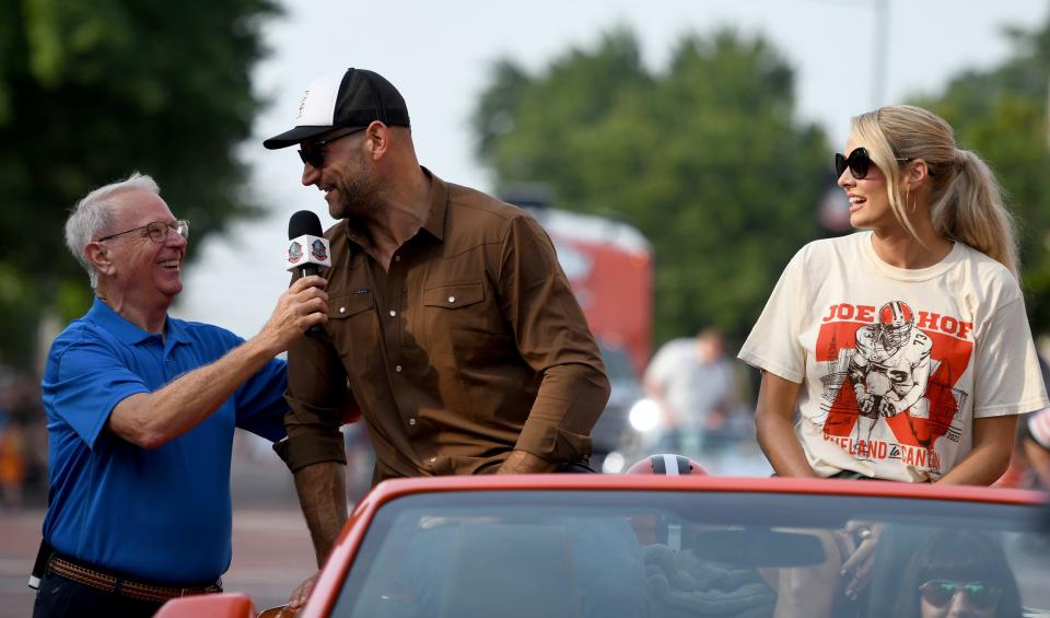 Enshrinee Joe Thomas with wife and presenter, Annie, stops for an interview Saturday during the 2023 Pro Football Hall of Fame Enshrinement Festival Canton Repository Grand Parade.