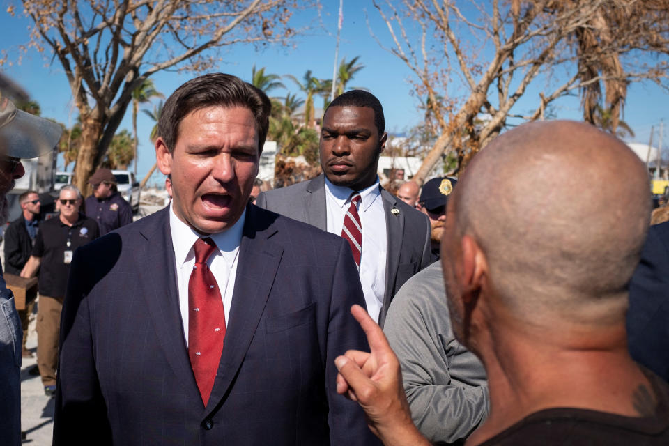 Florida Governor Ron DeSantis greets a supporter as he leaves after a news conference, almost one month after Hurricane Ian landfall in Fort Myers Beach, Florida, U.S., October 26, 2022. REUTERS/Marco Bello