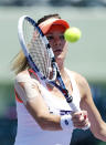 Agnieszka Radwanska, of Poland, returns to Dominika Cibulkova, of Slovakia, at the Sony Open Tennis tournament in Key Biscayne, Fla., Wednesday, March 26, 2014. (AP Photo/Joel Auerbach)