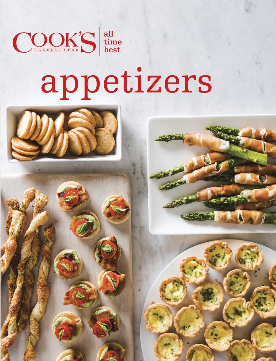 This image provided by America's Test Kitchen in October 2018 shows the cover for the cookbook "All-Time Best Appetizers." It includes a recipe for Herbed Spinach Dip. (America's Test Kitchen via AP)