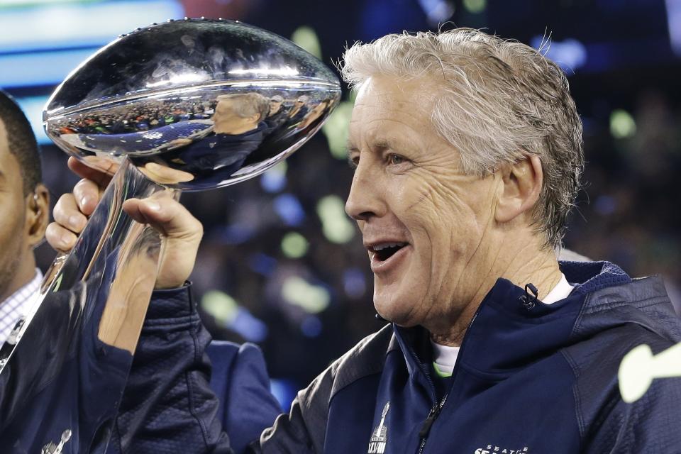 FILE - Seattle Seahawks coach Pete Carroll holds the the Vince Lombardi Trophy after the Seahawks defeated the Denver Broncos 43-8 in Super Bowl XLVIII, in East Rutherford, N.J., Feb. 2, 2014. Pete Carroll is out after 14 seasons as the head coach of the Seattle Seahawks, responsible for two NFC championships and the only Super Bowl title in franchise history during his long tenure. The 72-year old coach is moving into an advisory role with the organization, according to a statement from owner Jody Allen on Wednesday, Jan. 10, 2024. (AP Photo/Julio Cortez, File)