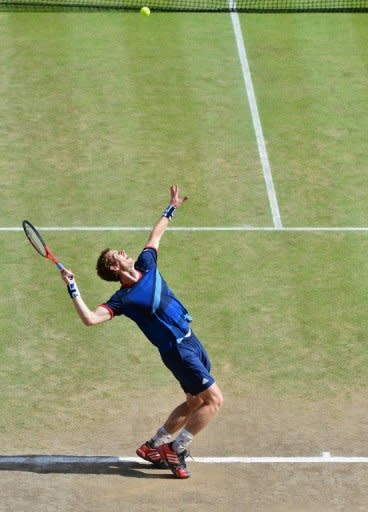 Andy Murray serves to Roger Federer during the Olympic men's singles final. Murray got his wish that the final would be staged with the Centre Court roof open as he felt his Wimbledon defeat was in part due to Federer thriving after a switch to indoor play