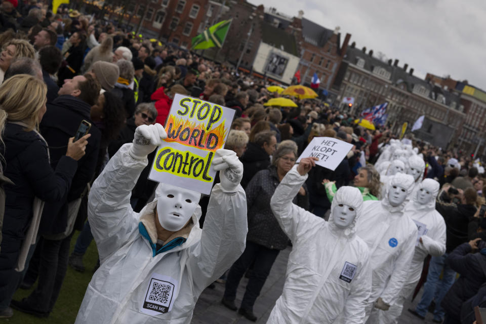 Several thousands of people defied a ban Sunday to gather and protest the Dutch government's coronavirus lockdown measures, in Amsterdam, Netherlands, Sunday, Jan. 2, 2022. The municipality of the Dutch capital banned the protest, saying police had indications some demonstrators could be attending "prepared for violence." (AP Photo/Peter Dejong)