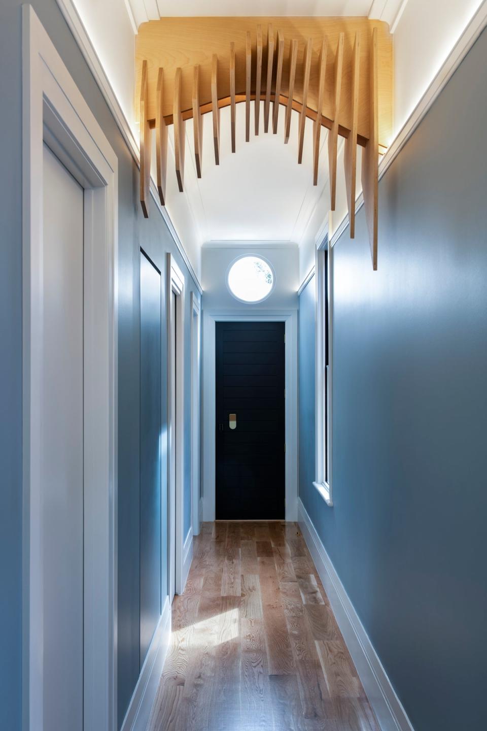 AFTER: The hallway is painted a light blue that continues into a front bedroom—this is where Nathan and Iman’s families will stay when they come to visit.