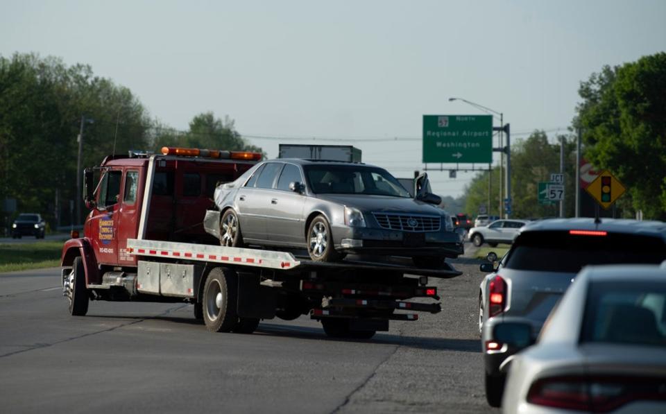 The Cadillac driven by the fugitives is towed away on Monday (Denny Simmons)