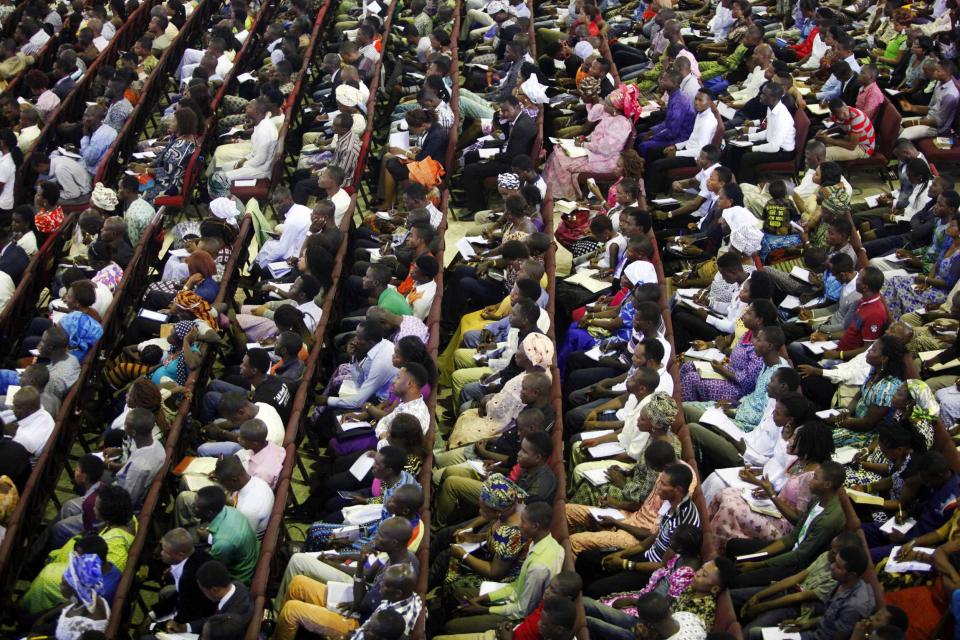 Worshippers listen to a sermon at the Living Faith Church, also known as the Winners' Chapel, in Ota district, Ogun state, some 60 km (37 miles) outside Nigeria's commercial capital Lagos September 28, 2014. Hundreds of millions of dollars change hands each year in Nigeria's popular Pentecostal "megachurches", which are modelled on their counterparts in the United States. Some of these churches can hold more than 200,000 worshippers and, with their attendant business empires, they constitute a significant section of the economy, employing tens of thousands of people and raking in tourist dollars, as well as exporting Christianity globally. To match Insight NIGERIA-MEGACHURCHES/ Picture taken September 28, 2014. REUTERS/Akintunde Akinleye (NIGERIA - Tags: RELIGION BUSINESS)