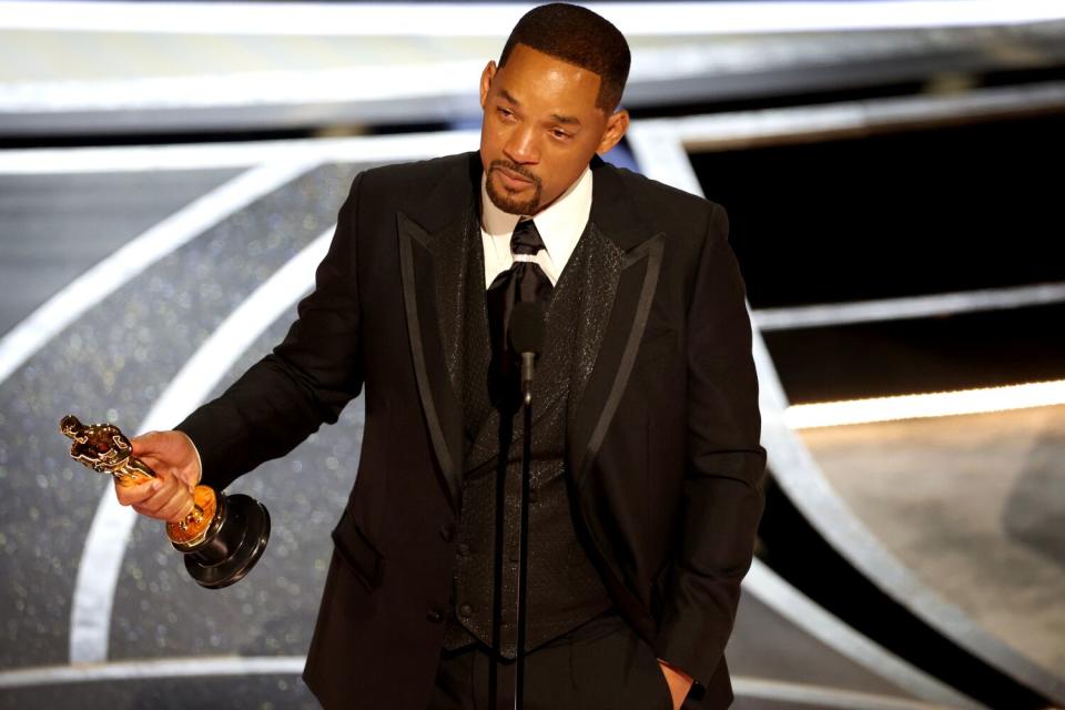 A tearful Will Smith holds his Oscar while giving his acceptance speech after winning the lead actor award.