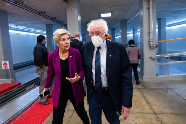 Sens. Elizabeth Warren (D-Mass.) and Bernie Sanders (I-Vt.), probably talking about corporate greed. (Photo: Bill Clark via Getty Images)