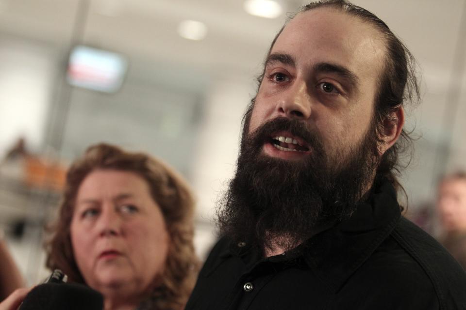 Canadian Greenpeace activist Alexandre Paul smiles as he arrives at the airport in Montreal