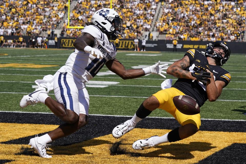 Utah State cornerback Jaiden Francois, left, breaks up a pass intended for Iowa wide receiver Nico Ragaini during the first half of an NCAA college football game, Saturday, Sept. 2, 2023, in Iowa City, Iowa. (AP Photo/Charlie Neibergall) | AP