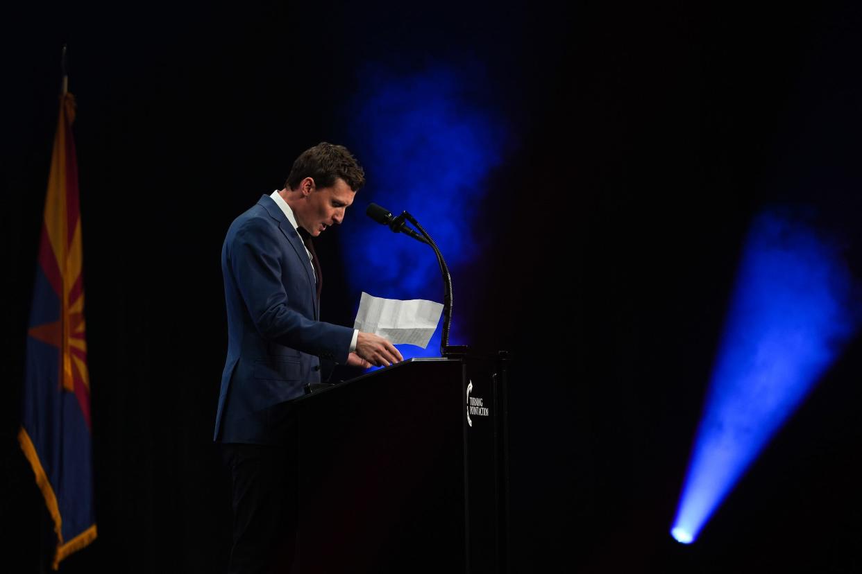 Blake Masters, Republican candidate for U.S. Senate, pauses to check his notes whiles delivering a speech during a Unite and Win rally held by Turning Point Action at the Arizona Financial Theatre on Aug. 14, 2022, in Phoenix.