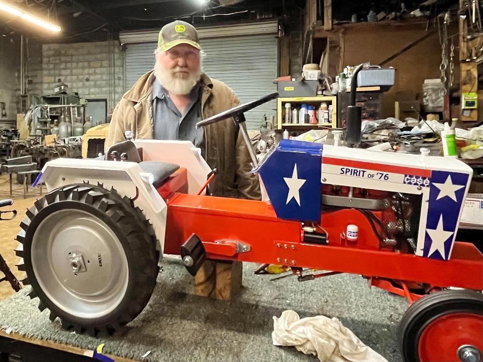 Don Turner of Hokes Bluff is pictured with a Spirit of '76 pedal tractor he built. Turner's half-scale but exact replicas of noted farm tractors have gained attention from coast to coast.