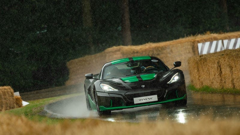 A photo of a black and green Rimac Nevera at Goodwood. 