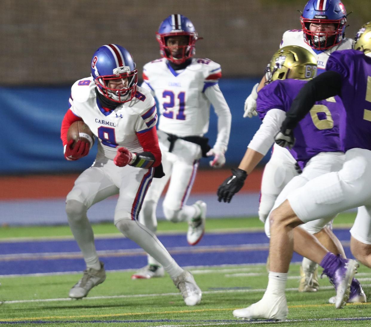 Carmel's Damien Santiago (8) intercepts a Christian Brothers Academy pass during the Class AA state semifinal playoff game at Middletown High School Nov. 25, 2023.