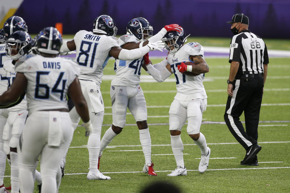 Tennessee Titans safety Amani Hooker, right, celebrates with teammates after intercepting a pass during the second half of an NFL football game against the Minnesota Vikings, Sunday, Sept. 27, 2020, in Minneapolis. The Titans won 31-30. (AP Photo/Bruce Kluckhohn)