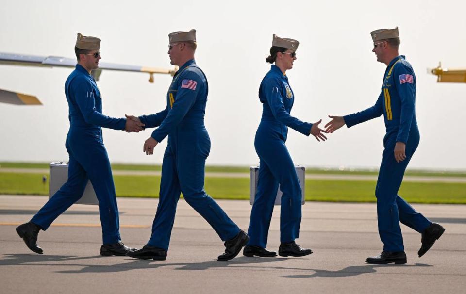 The Blue Angels pilots greeted each other after arriving at the New Century AirCenter on Thursday.