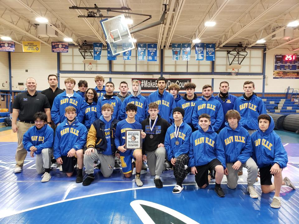 The Manville wrestling team after winning the Mike Dessino Invitational on Dec. 18, 2021