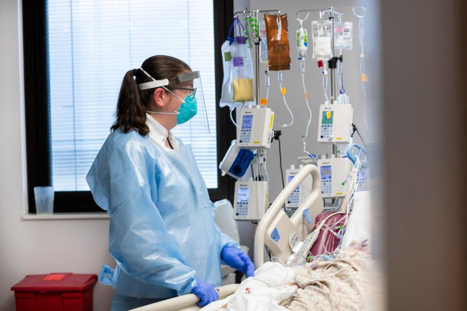 A patient with COVID-19 is cared for in this photo from Dec. 18, 2021 in the fourth-floor intensive care unit at Cleveland Clinic Akron General.