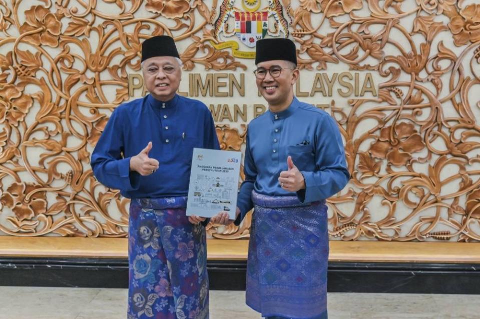 Caretaker prime minister Datuk Seri Ismail Sabri Yaakob with caretaker finance minister Datuk Seri Tengku Zafrul Abdul Aziz holding the Budget 2023 in Parliament, October 7, 2022. — Picture by Hari Anggara