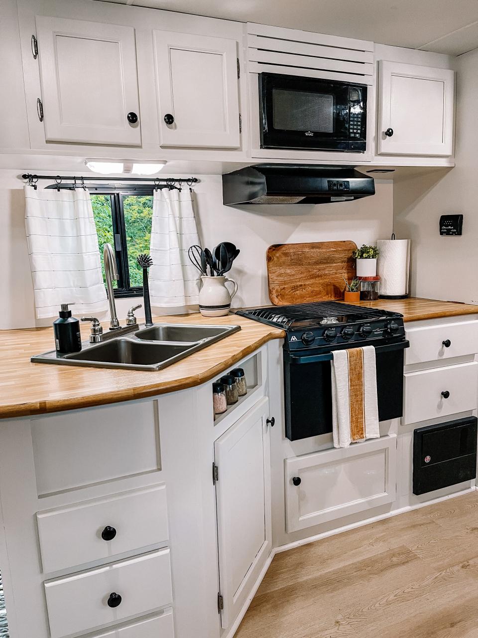 A fresh lick of paint and new hardware gave the cabinets a facelift in this 2014 camper. Dated window coverings were taken down and replaced with these repurposed dish towels. The countertops were covered in a woodgrain contact paper, but Chandler feels they may eventually install butcher block. Fountain City, April 14, 2023