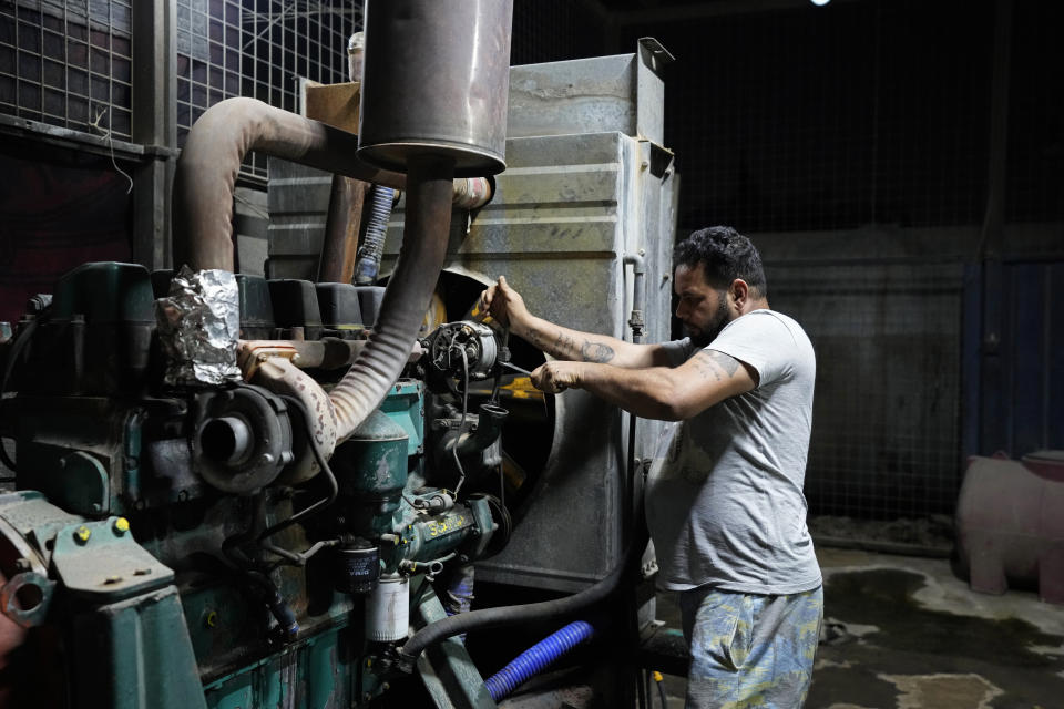 Aqeel Abdullah prepares an electricity generator to power private homes in Baghdad, Iraq, Tuesday, July 12, 2022. Private generators are ubiquitous in parts of the Middle East, spewing hazardous fumes into homes and business across the country, almost 24 hours a day. As the world looks for renewable energy to tackle climate change, Lebanon, Iraq, Gaza and elsewhere rely on diesel-powered private generators just to keep the lights on. The reason is state failure: In multiple countries, governments can’t maintain a functioning central power network, whether because of war, conflict or mismanagement and corruption. (AP Photo/Hadi Mizban)