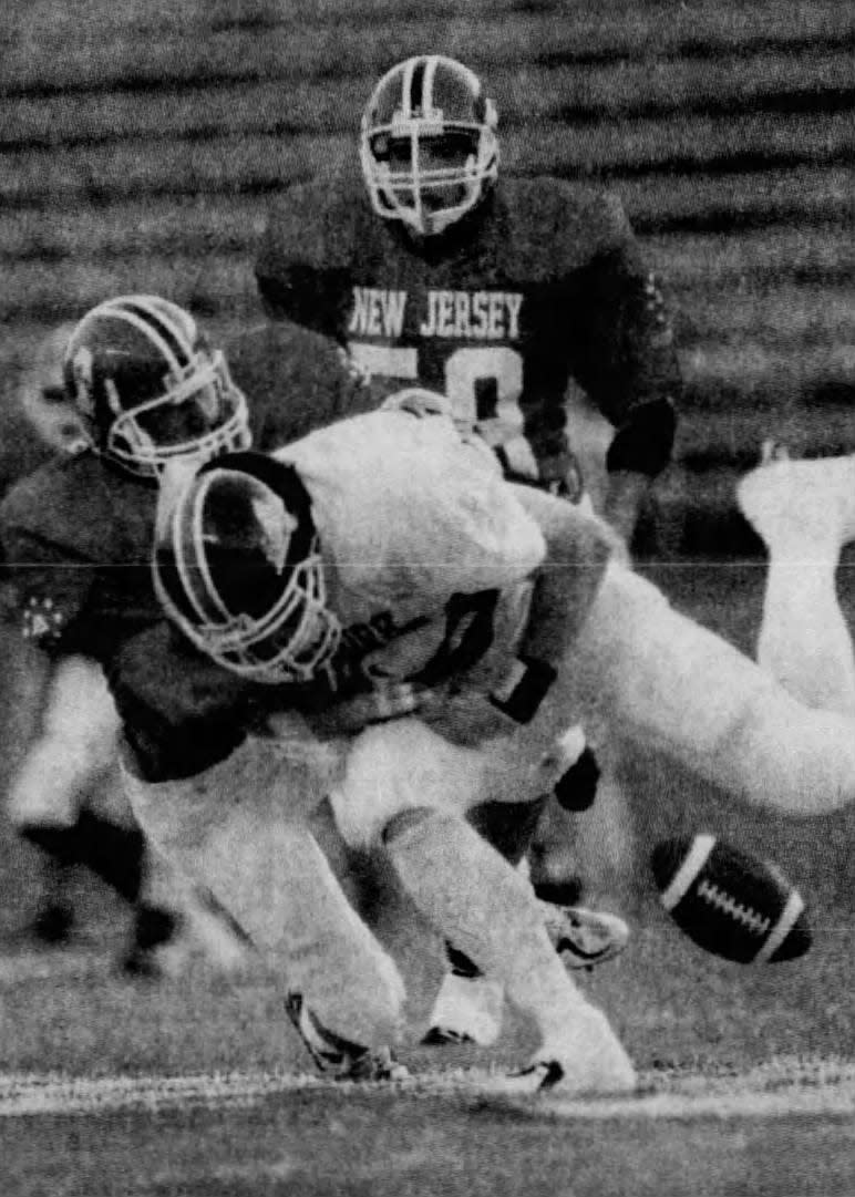 New Jersey’s Shawn Mayer of Hillsborough, left, tackles New York’s Sean Ryan.