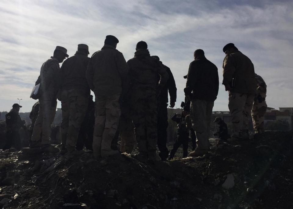 Iraqi army and special forces commanders gather to discuss battle plans in the eastern section of Mosul, Iraq, Thursday, Dec. 29, 2016. Iraqi troops backed by U.S.-led airstrikes pushed deeper into eastern Mosul on Thursday in a multi-pronged assault after a two-week lull in the operation to retake the Islamic State-held city. (AP Photo/Hamza Hendawi)