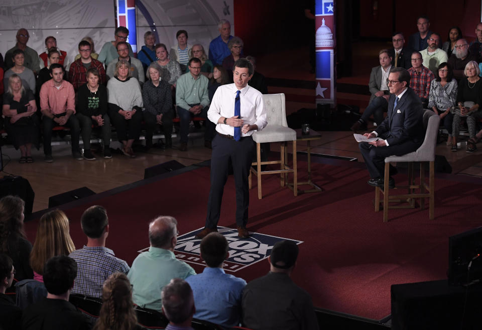 Democratic presidential candidate South Bend, Ind., Mayor Pete Buttigieg, center, answers a question during a FOX News Channel town hall moderated by Chris Wallace, center right, Sunday, May 19, 2019, in Claremont, N.H. (AP Photo/Jessica Hill)