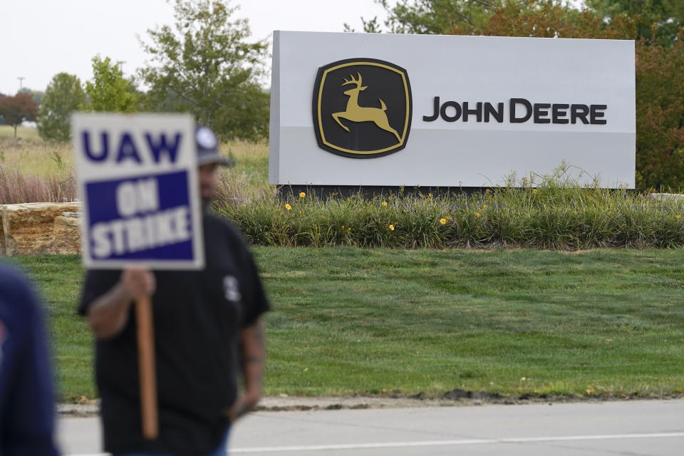 A member of the United Auto Workers strikes outside of a John Deere plant, Wednesday, Oct. 20, 2021, in Ankeny, Iowa. About 10,000 UAW workers have gone on strike against John Deere since last Thursday at plants in Iowa, Illinois and Kansas. (AP Photo/Charlie Neibergall)