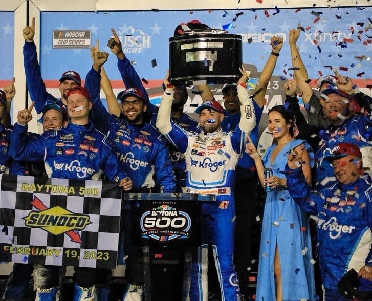 Ricky Stenhouse hoists the Harley J. Earl trophy after winning the 65th Daytona 500 on Feb. 19, 2023.