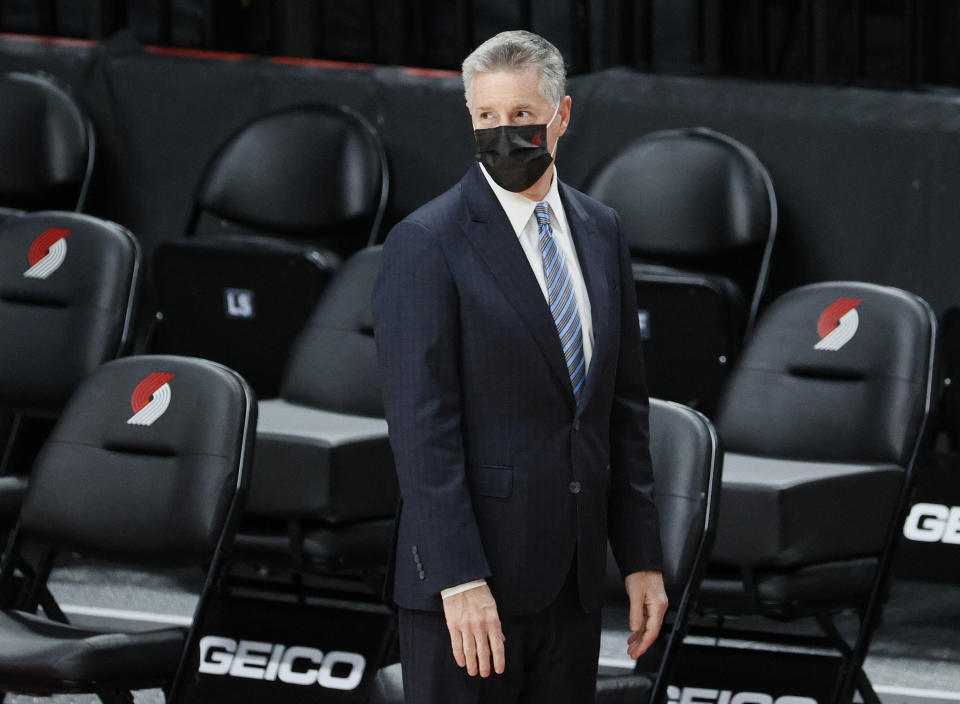 Neil Olshey looks on from courtside during warm-ups.