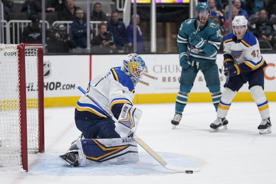 St. Louis Blues goaltender Thomas Greiss, left, deflects a shot against the San Jose Sharks during the first period of an NHL hockey game in San Jose, Calif., Thursday, March 2, 2023. (AP Photo/Godofredo A. Vásquez)