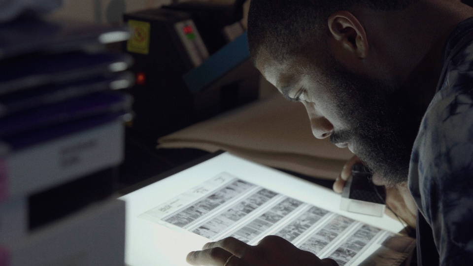 The new documentary "Grain" explores the stories of those committed to using film in modern day photography including New York photographer Andre D. Wagner, who is seen looking at a sheet of negatives in his darkroom in Brooklyn.