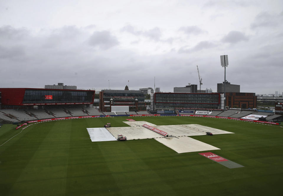 The pitch area is seen covered ahead of the fourth day of the third cricket Test match between England and West Indies at Old Trafford in Manchester, England, Monday, July 27, 2020. (Martin Rickett/Pool via AP)