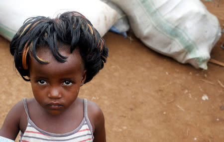 A Congolese child, whose family fled from ethnic fighting in Democratic Republic of Congo by fleeing on a boat across Lake Albert, looks on at United Nations High Commission for Refugees (UNHCR) reception center in Kyangwali refugee settlement camp, Uganda March 19, 2018. REUTERS/James Akena