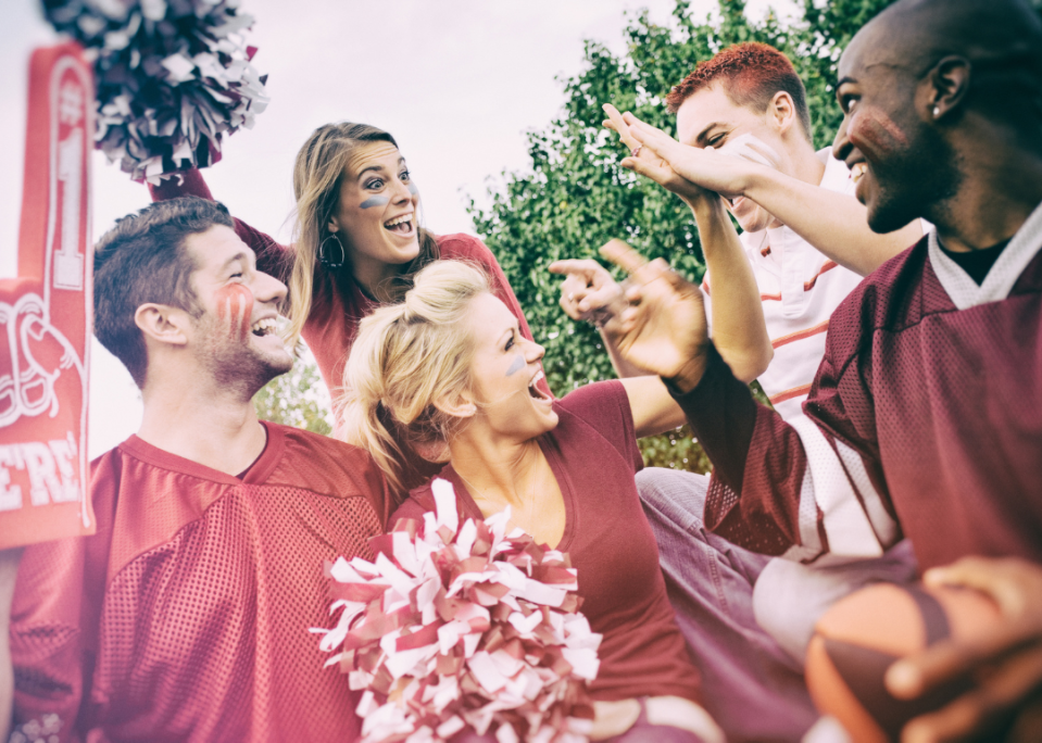 College students laughing and having fun at a tailgate party.