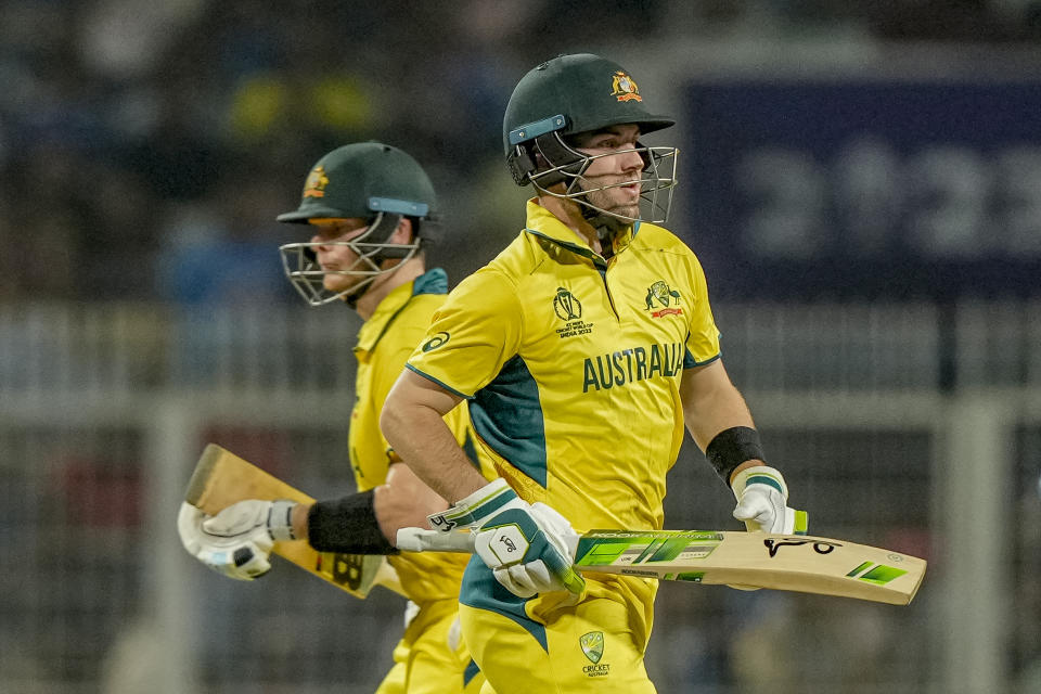 Australia's Josh Inglis, right, and Steve Smith run between the wickets during the ICC Men's Cricket World Cup second semifinal match between Australia and South Africa in Kolkata, India, Thursday, Nov. 16, 2023. (AP Photo/Mahesh Kumar A.)