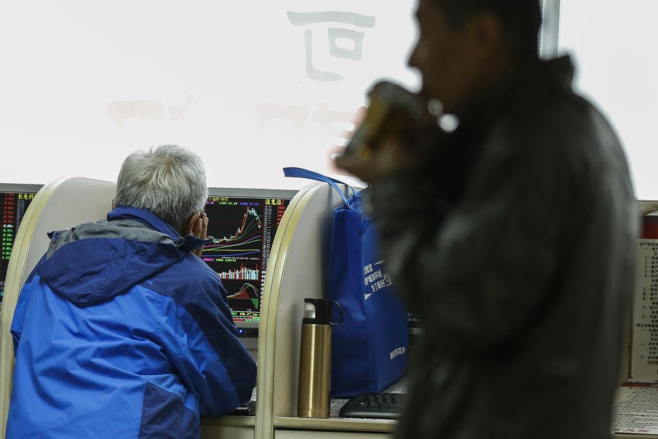 Chinese investors monitor stock prices at a brokerage house in Beijing, Wednesday, Oct. 23, 2019. Asian stock markets followed Wall Street lower Wednesday after major companies reported mixed earnings and an EU leader said he would recommend the trade bloc allow Britain to delay its departure. (AP Photo/Andy Wong)