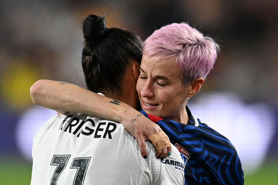 Gotham FC's Ali Krieger hugs OL Reign's Megan Rapinoe as she is helped off the pitch after an injury in the early minutes of the National Women's Soccer League final match between the two teams at Snapdragon Stadium in San Diego, California, on Nov. 11, 2023. (Robyn Beck / AFP via Getty Images)