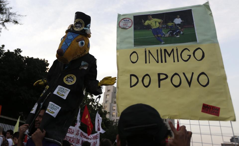 A demonstrator holds a banner during a protest against the 2014 World Cup in Rio