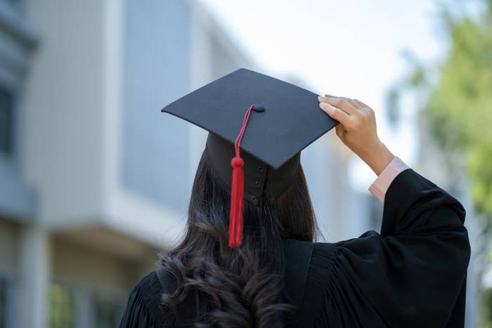 a person with a graduation cap and gown on