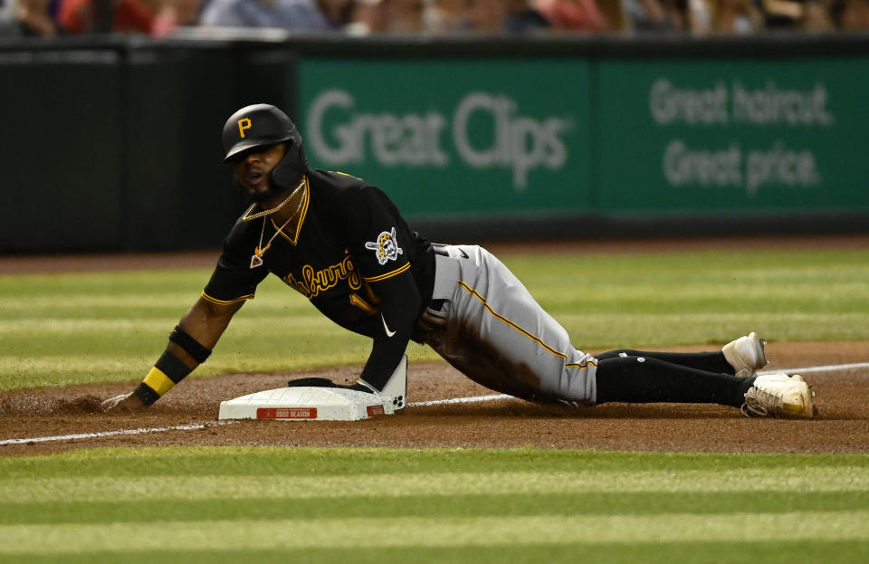 PHOENIX, ARIZONA - AUGUST 09: Rodolfo Castro #14 of the Pittsburgh Pirates slides into third base as his cell phone falls out of his pocket during the fourth inning of a game against the Arizona Diamondbacks at Chase Field on August 09, 2022 in Phoenix, Arizona. (Photo by Norm Hall/Getty Images)