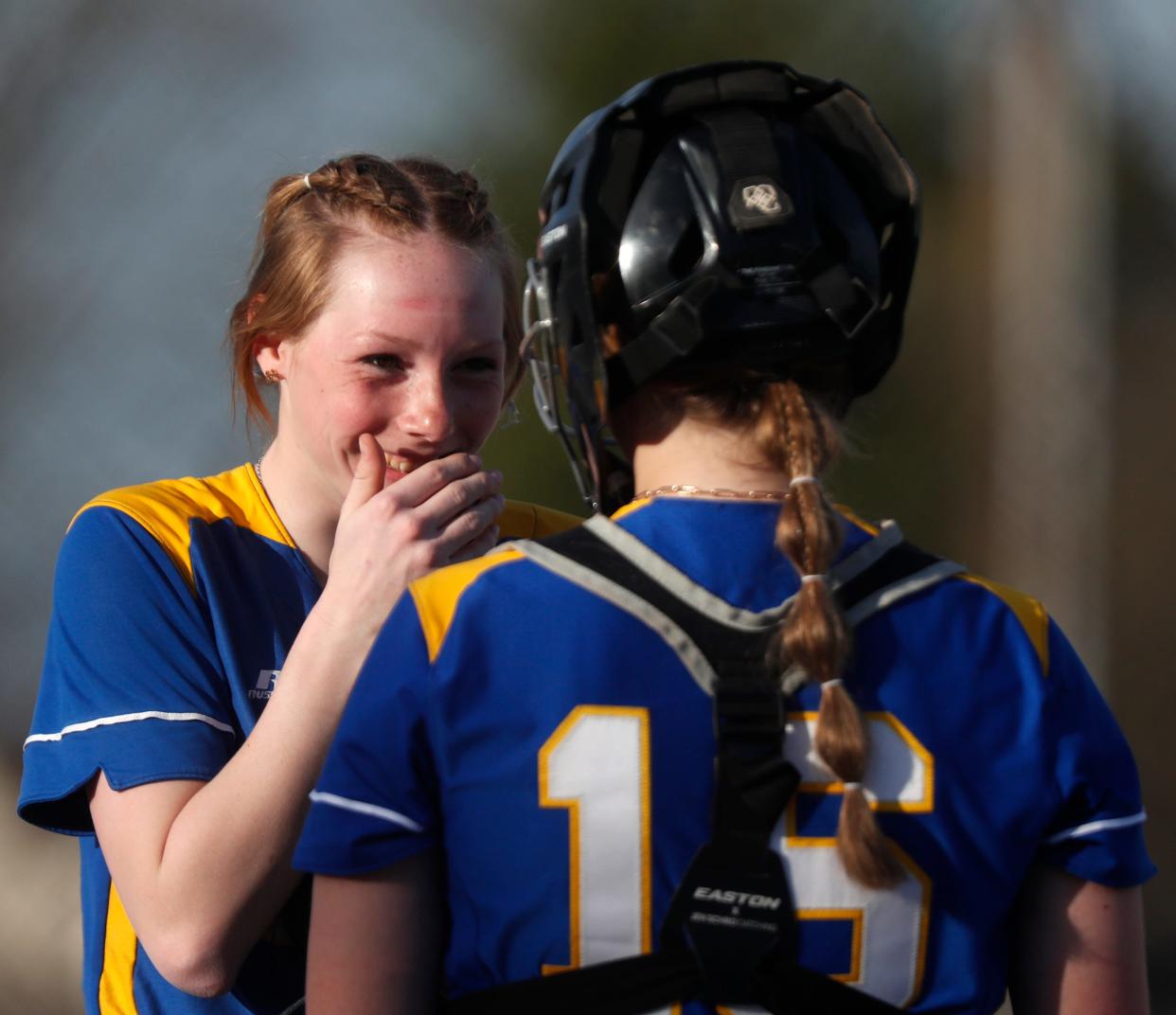 Crawfordsville Athenians Olivia Hedrick (11) and Crawfordsville Athenians Christina Susdorf (16) laugh during the IHSAA softball game against the West Lafayette Red Devils, Monday, April 10, 2023, at West Lafayette High School in West Lafayette, Ind. West Lafayette Red Devils won 19-9.