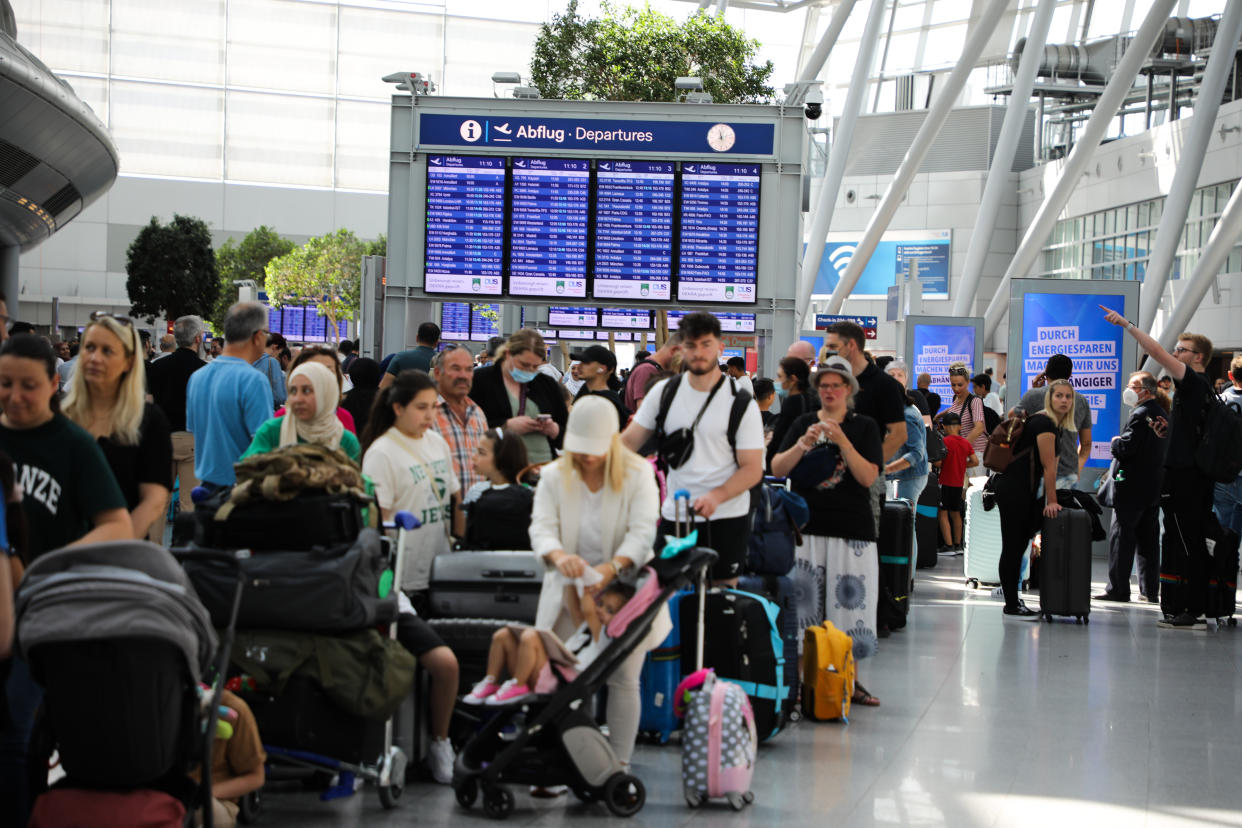 DUSSELDORF, GERMANY - JUNE 25: People wait in long lines amid summer travel chaos due to lack of personnel at Dusseldorf International Airport in Dusseldorf, North Rhine-Westphalia, Germany on June 25, 2022. Flight delays and cancellations continued to stall air travelers. (Photo by Kadir Ilboga/Anadolu Agency via Getty Images)