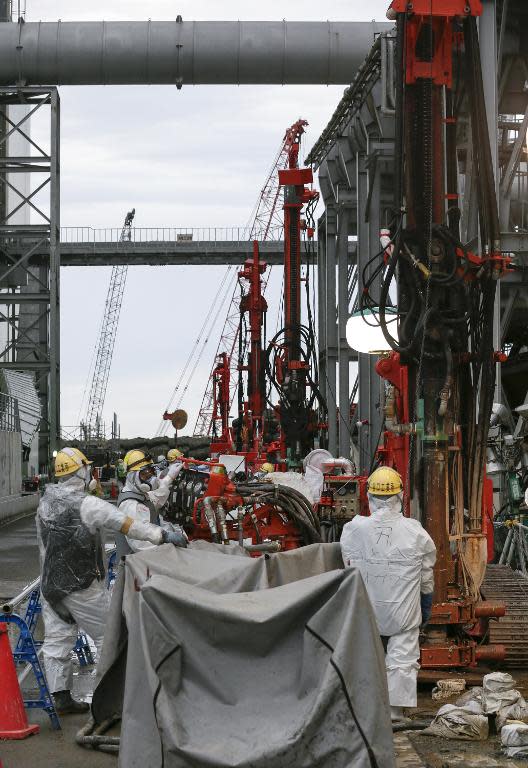 Workers during the construction of an ice wall at the tsunami-crippled Fukushima nuclear power plant in Okuma, Fukushima Prefecture on July 9, 2014