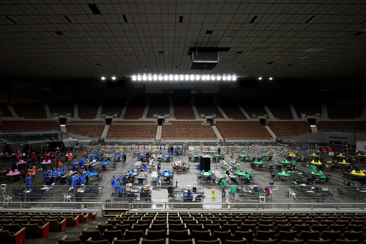 Maricopa County ballots cast in the 2020 general election are examined and recounted by contractors working for Florida-based company, Cyber Ninjas, Thursday, May 6, 2021 at Veterans Memorial Coliseum in Phoenix. (Matt York/AP)      